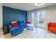 Living room with blue couch, orange chair, and French doors at 182 Water Oak Dr, Pineville, NC 28134