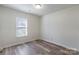 Simple bedroom with wood-look floors and a window at 210 Lauren Dr, Indian Trail, NC 28079