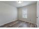 Bright bedroom with wood-look floors and a window at 210 Lauren Dr, Indian Trail, NC 28079