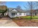 Front view of a charming white house with a gray roof and small porch at 210 Lauren Dr, Indian Trail, NC 28079