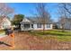 White house with gray roof, front porch, and landscaped yard at 210 Lauren Dr, Indian Trail, NC 28079