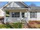 Quaint front porch with white railings and access to the front door at 210 Lauren Dr, Indian Trail, NC 28079