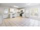 Bright kitchen with white cabinets, stainless steel appliances, and tile floor at 210 Lauren Dr, Indian Trail, NC 28079