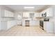 White kitchen features stainless steel appliances and access to backyard at 210 Lauren Dr, Indian Trail, NC 28079