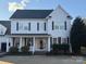 Charming two-story home featuring a welcoming front porch and traditional architectural details at 2113 Woodbend Trl, Tega Cay, SC 29708