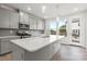 Modern kitchen with gray cabinets, island, and stainless steel appliances at 2314 Donnelly Hills Ln, Charlotte, NC 28262