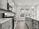 Modern kitchen with gray cabinets, island, and stainless steel appliances at 2314 Donnelly Hills Ln, Charlotte, NC 28262