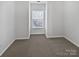 Well-lit bedroom featuring neutral carpeting at 2653 Early Flight Dr, Charlotte, NC 28262