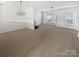 Spacious living room with neutral carpeting and a fireplace at 2653 Early Flight Dr, Charlotte, NC 28262