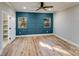 Spacious bedroom with blue accent wall and hardwood floors at 277 Melrose Sw Dr, Concord, NC 28025