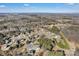 Aerial image showing a residential area with tree-lined streets and homes at 305 Goldfinch Ct, Shelby, NC 28150