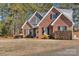 House exterior featuring brick, stone accents, and a well-maintained lawn at 305 Goldfinch Ct, Shelby, NC 28150