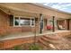 Inviting front porch with classic brickwork, columns, and comfortable seating area at 3050 Wilkesboro Hwy, Statesville, NC 28625