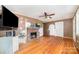 Cozy living room featuring a brick fireplace and hardwood floors at 3050 Wilkesboro Hwy, Statesville, NC 28625