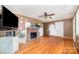 Cozy living room featuring hardwood floors, a brick fireplace, and lots of potential at 3050 Wilkesboro Hwy, Statesville, NC 28625