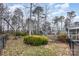 Backyard with mature trees, outbuilding, and lush greenery, fenced for added privacy at 330 Regency Rd, Salisbury, NC 28147