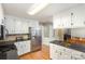 Well-lit kitchen with white cabinets, stainless steel appliances, and hardwood floors at 330 Regency Rd, Salisbury, NC 28147