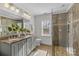 Modern bathroom with a double vanity and a walk-in shower at 3319 Holt St, Charlotte, NC 28205