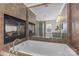 Luxurious bathroom with a soaking tub and a fireplace at 3319 Holt St, Charlotte, NC 28205