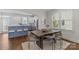 Open concept dining area with wooden table, adjacent to a blue and white kitchen at 3319 Holt St, Charlotte, NC 28205