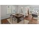 Modern dining area with a rustic wood table and six gray upholstered chairs at 3319 Holt St, Charlotte, NC 28205