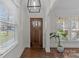 Light-filled entryway with hardwood floors, a statement light fixture, and access to the living room at 3319 Holt St, Charlotte, NC 28205