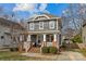 Two-story craftsman home with gray siding, brick accents, and a welcoming front porch at 3319 Holt St, Charlotte, NC 28205