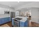 Modern kitchen island with a gas cooktop and a view into the adjacent dining area at 3319 Holt St, Charlotte, NC 28205