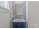 Stylish powder room with a navy vanity and patterned wallpaper at 3319 Holt St, Charlotte, NC 28205