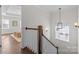 Upper hallway with a view into a bedroom and a stylish light fixture at 3319 Holt St, Charlotte, NC 28205