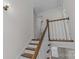 Upstairs hallway with wooden staircase and doors to bedrooms at 3319 Holt St, Charlotte, NC 28205