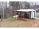 Covered patio with seating area and grill next to a metal shed at 334 Stanley Spencer Mtn Rd, Gastonia, NC 28056