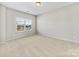 Bright bedroom featuring carpeted floors and a large window at 368 Pleasant Hill Se Dr, Concord, NC 28025