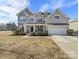 Two-story house with gray siding, stone accents, and a two-car garage at 368 Pleasant Hill Se Dr, Concord, NC 28025