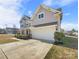 Two-story house with gray siding, stone accents, and a two-car garage at 368 Pleasant Hill Se Dr, Concord, NC 28025