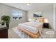 Virtually staged main bedroom with a plush bed and neutral color scheme at 368 Pleasant Hill Se Dr, Concord, NC 28025