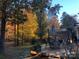 Deck with patio furniture and umbrella, surrounded by autumn trees at 3812 Leela Palace Way, Fort Mill, SC 29708