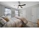 Cozy bedroom with striped bedding and ceiling fan at 3812 Leela Palace Way, Fort Mill, SC 29708