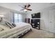 Relaxing bedroom with a ceiling fan and mounted TV at 3812 Leela Palace Way, Fort Mill, SC 29708