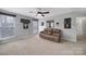 Bright bonus room featuring a brown leather couch and large windows offering natural light at 3812 Leela Palace Way, Fort Mill, SC 29708