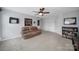 Bonus room with a leather couch, built-in shelving, and double doors at 3812 Leela Palace Way, Fort Mill, SC 29708