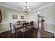 Formal dining room with hardwood floors and view into kitchen at 3812 Leela Palace Way, Fort Mill, SC 29708