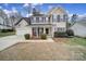 Two-story house with a covered porch, two-car garage, and manicured lawn at 3812 Leela Palace Way, Fort Mill, SC 29708