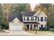 Two-story house with beige siding, black shutters, and a large front yard at 3812 Leela Palace Way, Fort Mill, SC 29708