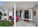 Inviting front porch with red chairs and a table, creating a cozy atmosphere at 3812 Leela Palace Way, Fort Mill, SC 29708