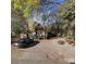 A-frame home's exterior view, surrounded by trees and gravel driveway at 503 Welsh Ave, Monroe, NC 28112