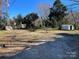 Large backyard with gravel driveway and storage shed at 518 W White St, Chester, SC 29706