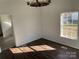 Bright dining room with dark wood floors and a wagon wheel chandelier at 518 W White St, Chester, SC 29706