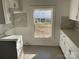 White kitchen cabinets and gray tile backsplash at 518 W White St, Chester, SC 29706