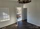 Living room with dark floors and access to front porch at 518 W White St, Chester, SC 29706